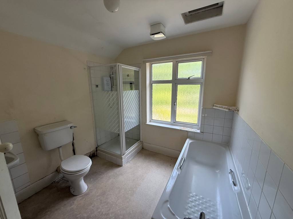 Lot: 143 - TWO-BEDROOM SEMI-DETACHED HOUSE WITH DRIVEWAY - Tiled bathroom with bank, shower, WC and sink basin
